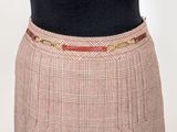 a woman that is wearing a skirt with a belt