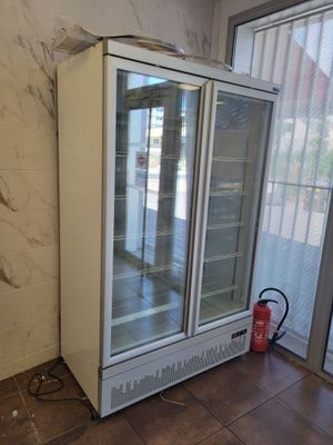 an image of a refrigerator in a room with a fire extinguisor