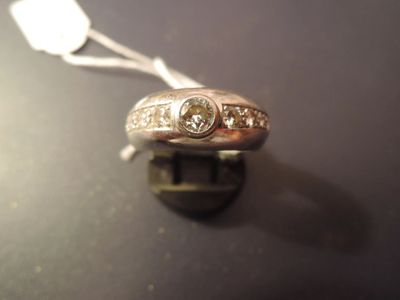 a silver ring with three diamonds on it on a table