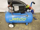 an image of a blue air compressor sitting on top of a cement floor