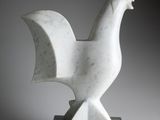 sculpture of a white rooster on a marble base on a gray background