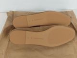 stradivarius shoes in a brown bag on a white surface