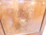 a wooden cabinet with a vase on top of it