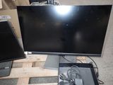 two monitors sitting on a pallet next to each other