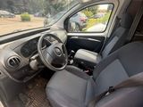 the interior of a car with the door open and the driver ' s seat down