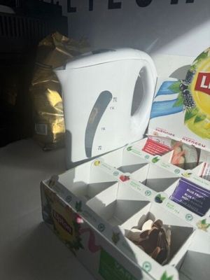 a box of tea and a tea bag on a table