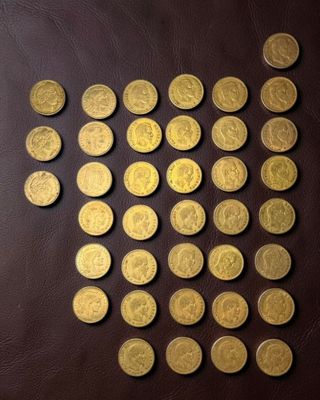 some gold coins are arranged in a circle on a brown surface