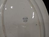 a close up of a white plate with a blue stripe on it