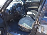 the interior of a car with the door open and the driver ' s seat down