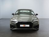 the front view of a grey audi vehicle parked in a showroom