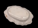 a white plate with an oval design on it
