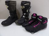 pair of black and pink motorcycle boots sitting on a white table