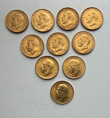 a close up of a bunch of gold coins on a white surface