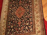 an image of a rug on a wooden floor next to a red rug
