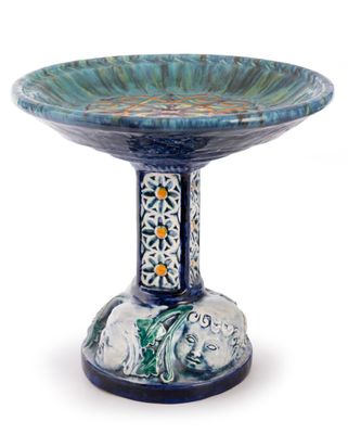 a blue and green bowl with a bird on it