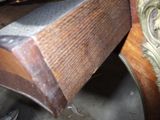 a wooden bench that has a clock on top of it