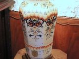 a large vase sitting on top of a wooden table