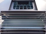 a close up of a grill with four burners on top of it