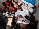 many pairs of shoes that are sitting in a box