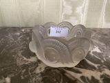 a small glass candle holder on a marble table