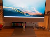 a computer monitor sitting on a desk with a keyboard and mouse