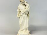 a statue of a man holding a child in his arms