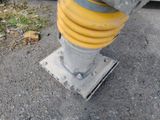 a yellow fire hydrant sitting on the side of the road