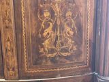 a large wooden cabinet with carvings on it
