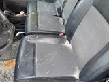 a dirty seat in the back of a truck