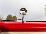 a close up of a red and white car ' s hood