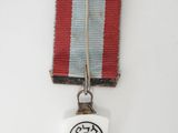 an image of a medal with a red, white and blue ribbon on it