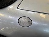 a close up of a car ' s hood with a hole in it