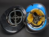 two helmets that are sitting side by side on a table