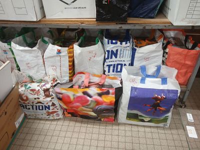 many bags of food sitting on a shelf in a store