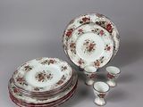 a lot of plates and cups sitting on a table