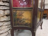 a cabinet that has a painting on the front of it