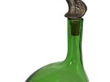 a green glass bottle with a bird on top of it