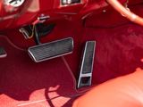 the interior of a red car with red carpeting and a red steering wheel