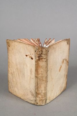an old book that is open on a table