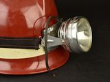 a red hard hat with a light attached to it
