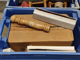 a blue container with a wooden handle in it