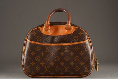 a brown and tan purse with a brown handle