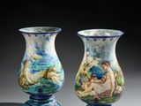 pair of blue and white vases with figures painted on them