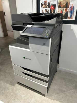 a multi - function printer sitting on the floor in a room