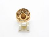 an image of a gold ring with a stone in the center