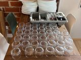 a wooden table with a bunch of cups and plates on it