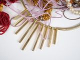 a close up of a necklace with beads and beads on it