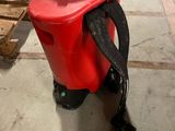 a red spray can sitting on the floor next to a pallet of wood