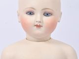 a small doll that is sitting on a white surface