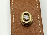 an image of a close up of a leather belt with a diamond in the center